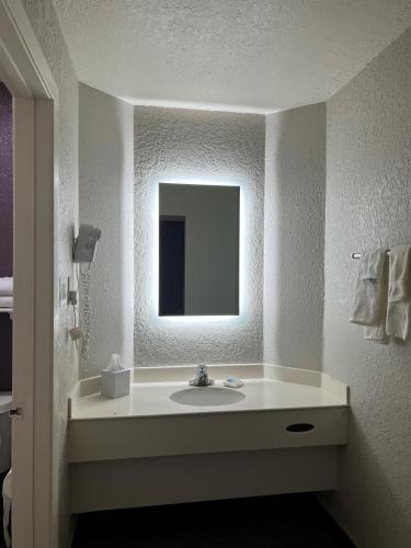 a bathroom with a sink and a mirror at La Quinta Inn by Wyndham Bossier City in Bossier City
