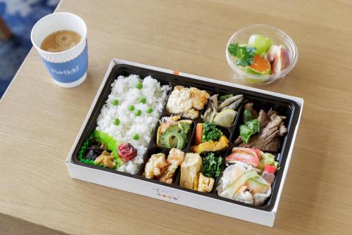 a tray of food with rice and vegetables and a cup of coffee at Fairfield by Marriott Kagoshima Sakurajima in Tarumizu
