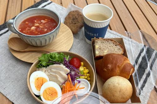 a table with a bowl of soup and a plate of food at Fairfield by Marriott Hyogo Tajima Yabu in Yabu