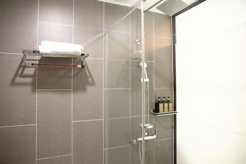 a shower with a glass door in a bathroom at Ramada by Wyndham Gangwon Sokcho in Sokcho