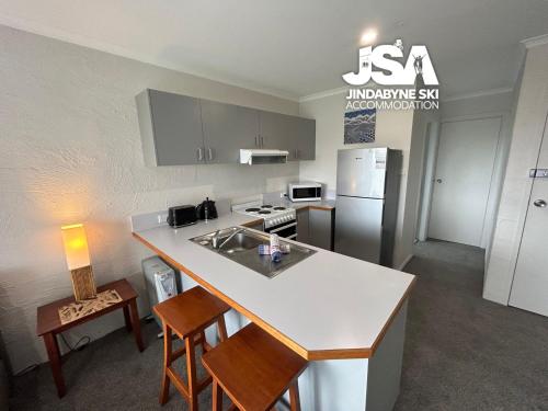 a kitchen with a sink and a counter top at Parkwood 4 in Jindabyne
