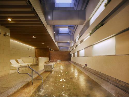 a long hallway with a pool of water in a building at Villa Fontaine Grand Tokyo Ariake in Tokyo