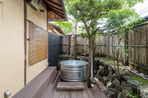 a barrel sitting on a deck next to a fence at n estate Kyoto-Arashiyama in Shimo saga