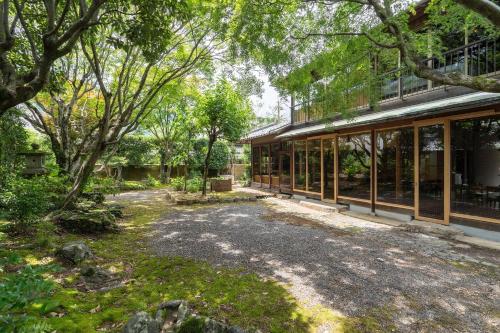 an external view of a building with windows and trees at n estate Kyoto-Arashiyama in Shimo saga