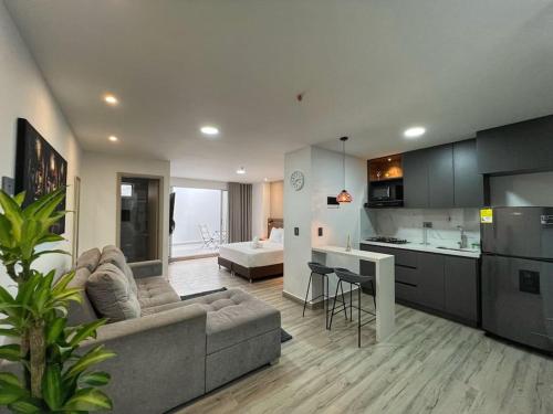 a large living room with a couch and a kitchen at Torre Zurich Luxury in Medellín