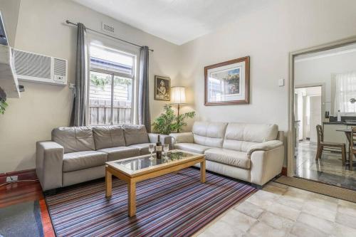 a living room with a couch and a coffee table at Spacious Urban Delight in Coburg in Melbourne