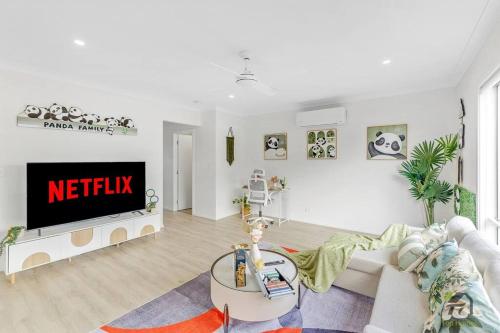 a living room with a couch and a tv at Serenity Stay in Richlands in Brisbane