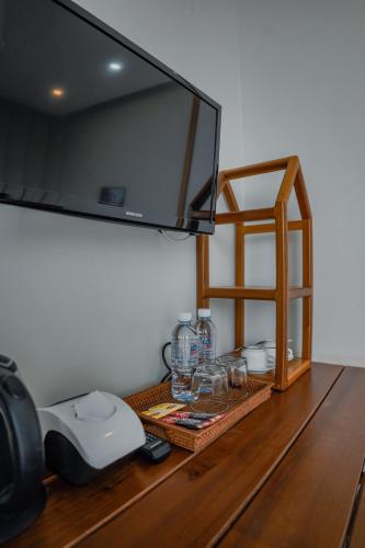 a television on top of a wooden table at Montagne Regency in Kampot