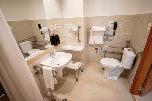 a bathroom with a toilet and a sink at Holiday Inn Manaus by IHG in Manaus