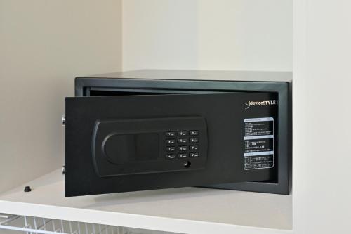 a microwave oven sitting on top of a shelf at アクアホテル小豆島リゾート in Shodoshima