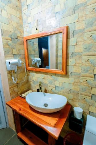 a bathroom with a sink and a mirror on a counter at Bac Ha Lodge Retreat in Bắc Hà