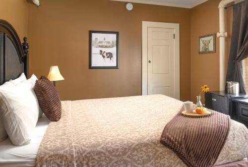 a bedroom with a bed with a white comforter at Whitneys Inn at Black Mountain in Jackson