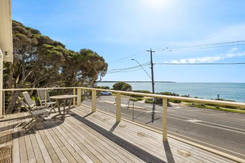 a balcony with a bench and a view of the ocean at Seaview Splendour in Point Lonsdale