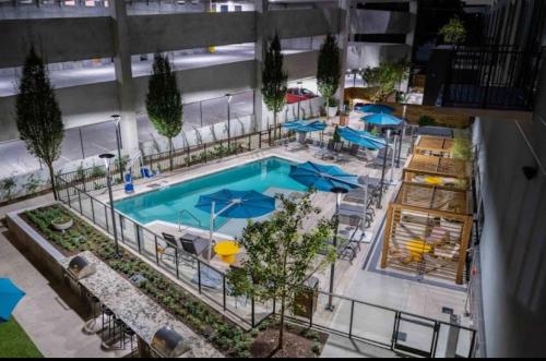 an overhead view of a pool with chairs and umbrellas at central located Modern west Midtown suite in Atlanta