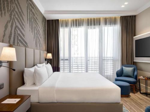 Postel nebo postele na pokoji v ubytování Mercure Riyadh Al Anoud