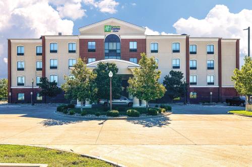 a large building with a parking lot in front of it at Holiday Inn Express Hotel & Suites Ennis by IHG in Ennis
