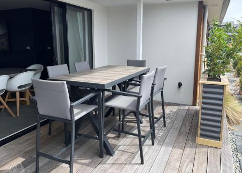 a dining table and chairs on a patio at Kingfisher Lodge in Lake Tekapo
