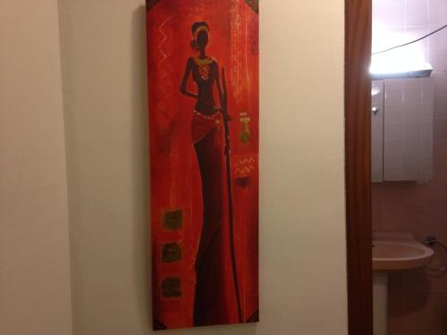 a painting of a woman on a wall in a bathroom at Apartamentos Calle Mayor in Castellón de la Plana