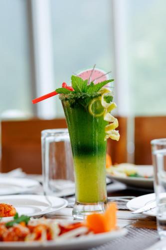 a green drink in a vase on a table at Thumki Resort, Balthali in Panauti