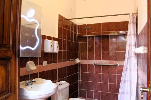 a bathroom with a toilet and a sink at Apart Hotel Loma Chica Quito in Quito