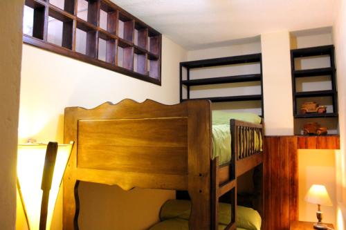 a bedroom with a bunk bed with a wooden bed frame at Apart Hotel Loma Chica Quito in Quito