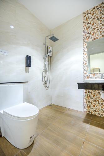 a bathroom with a toilet and a mirror at Love Here Poolvilla หัวหิน in Hua Hin