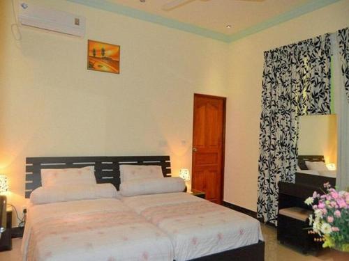 Katil atau katil-katil dalam bilik di Charming Holiday Lodge