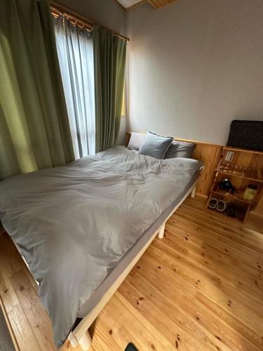 a large bed in a room with a window at Fuji Dome Glamping in Fujikawaguchiko
