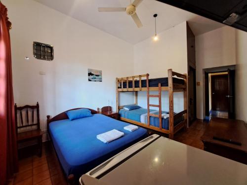 a bedroom with two bunk beds and a table at La posada del Virrey in Pucallpa