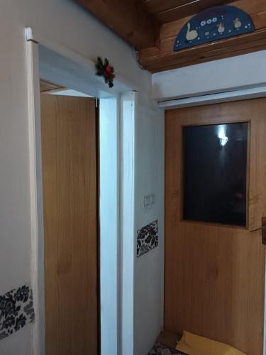 a room with a door and a television on the wall at Mountain Apartment Vlašić Babanovac in Vlasic