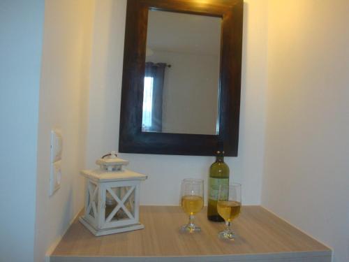 a table with two glasses of wine and a bottle at Chill Out Studio in Mýkonos City