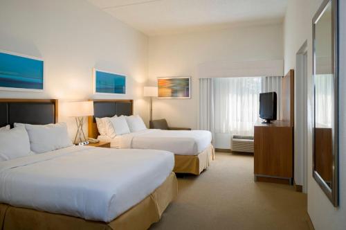 a hotel room with two beds and a television at Holiday Inn Express Hershey-Harrisburg Area by IHG in Hershey