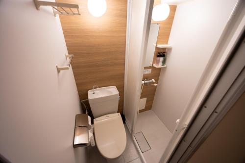 a small bathroom with a toilet in a room at Hotel Paul House in Tokyo