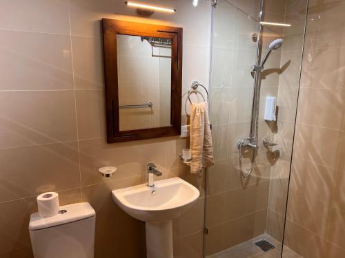 a bathroom with a toilet and a sink and a shower at AT ONE - with Nature Glamping Resort in Rekawa