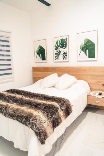 a bedroom with a bed with a brown blanket at Apto 203 - Casa bendita in Medellín