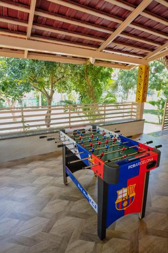a foosball table sitting in the middle of a room at ARS FARMSTAY in Munirābād