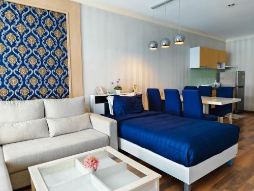 a living room with a couch and a table at My Resort Huahin by MR.JAY in Hua Hin