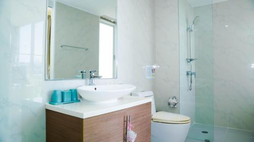 a bathroom with a sink and a toilet and a mirror at My Resort Huahin by MR.JAY in Hua Hin