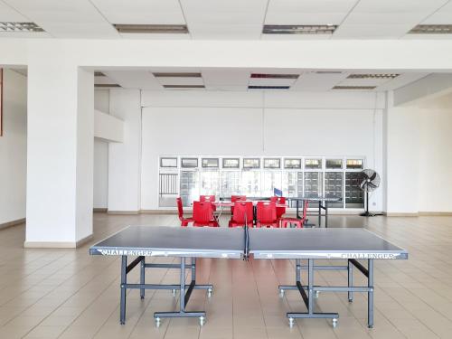 a ping pong table in a room with red chairs at KLIA One City 2 Room Taipan USJ 21 Puchong Putra Height Shah Alam Hi-Com Cyberjaya Putrajaya in Subang Jaya