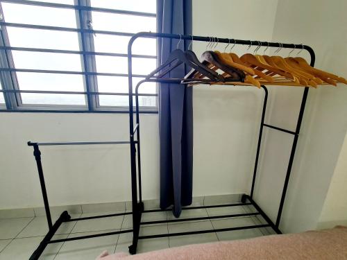 a rack with two umbrellas in a room at KLIA One City 2 Room Taipan USJ 21 Puchong Putra Height Shah Alam Hi-Com Cyberjaya Putrajaya in Subang Jaya