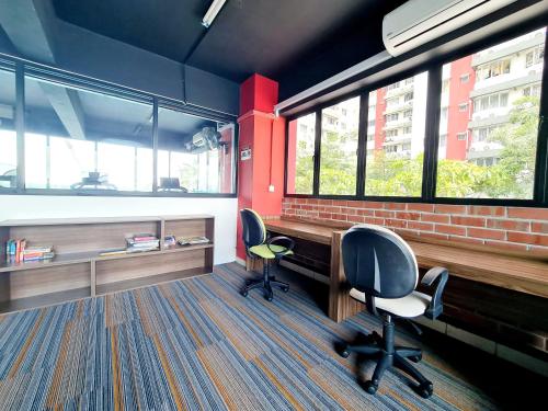 an office with two chairs and a desk and two windows at KLIA One City 2 Room Taipan USJ 21 Puchong Putra Height Shah Alam Hi-Com Cyberjaya Putrajaya in Subang Jaya