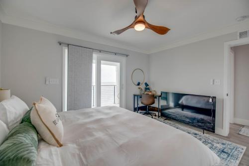 a white bedroom with a bed and a ceiling fan at Ritaville - Monthly Rental in Stock Island