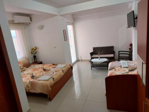 a bedroom with two beds and a living room at Villa & Apartments Antigona in Ohrid