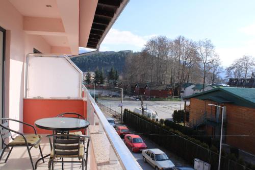 a balcony with a table and chairs and a view of a street at Villa & Apartments Antigona in Ohrid