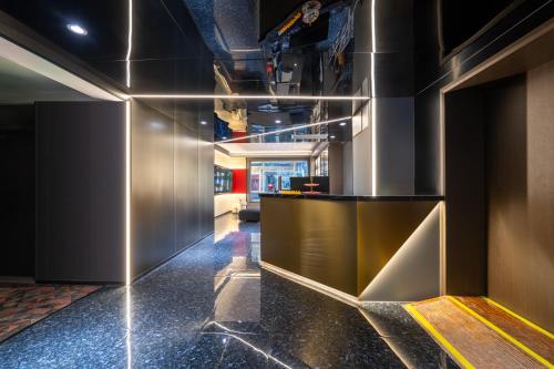 a lobby with a reception desk in a building at Yueta E-Sports Hotel-10min to Guangzhou East Railway Station&Entrance Exit J of Line 3 in Guangzhou