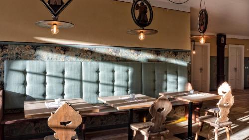a restaurant with tables and chairs in a room at Niedermairhof in Brunico