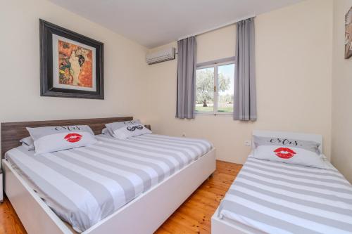 a bedroom with two beds and a window at Family friendly seaside apartments Iz, Iz - 22025 in Veli Iž