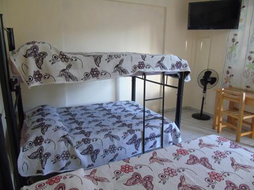 a bedroom with a bunk bed with a blanket at Tokali, GuestHouse in Mexico City