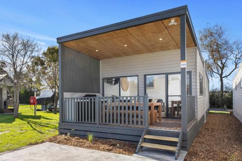 a tiny house with a porch and a deck at BIG4 Ingenia Holidays Inverloch in Inverloch