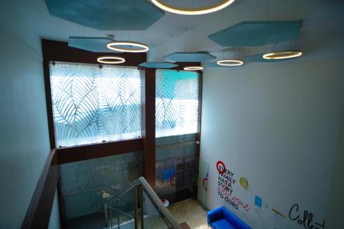 a room with a staircase and some windows at RAAJ PEARL in Chennai